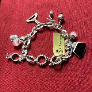 Vintage Premier Designs charm bracelet with a purse, a mirror, a hanger etc